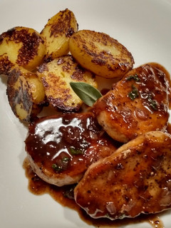 A picture of Pork Chops with Sage and Blackberry Pan Sauce.