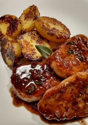 A picture of Pork Chops with Sage and Blackberry Pan Sauce.