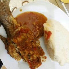 A picture of Fish curry served with Ugali.