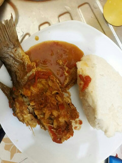 A picture of Fish curry served with Ugali.