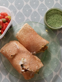 A picture of Spicy Potato-filled Dosa with Green Chilli Chutney.