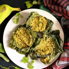 A picture of Lau Patay Kacha Kolar Paturi (Raw Banana steam cooked in Bottle Gourd Leaves - Bong style).
