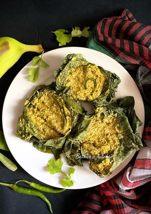 A picture of Lau Patay Kacha Kolar Paturi (Raw Banana steam cooked in Bottle Gourd Leaves - Bong style).
