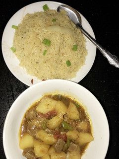 A picture of Spiced orange rice with meat and potatoes pepper soup.