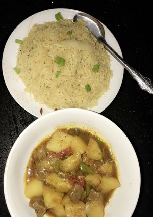 A picture of Spiced orange rice with meat and potatoes pepper soup.