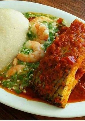 A picture of Semi with stew and okro soup with fresh fish and shrimps.