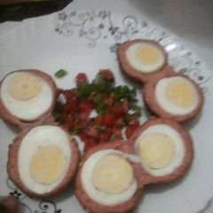 A picture of Scotch eggs served with kachumbari.