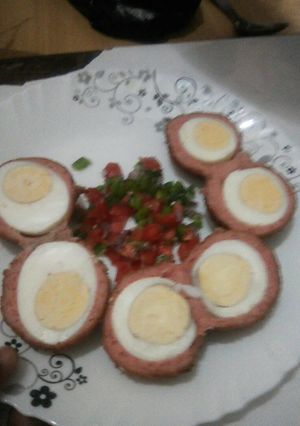 A picture of Scotch eggs served with kachumbari.