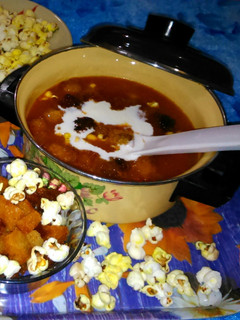 A picture of Expensive tomato soup with Fried Bread and Popcorns.