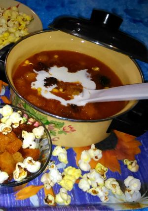A picture of Expensive tomato soup with Fried Bread and Popcorns.