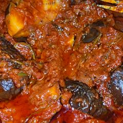 A picture of Greek Eggplant with Onion, Tomato, Dill, and Cilantro.
