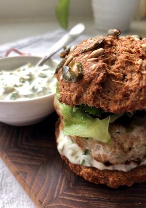A picture of Tuna burger with tartar sauce.