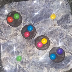 A picture of Dark chocolate with gems.