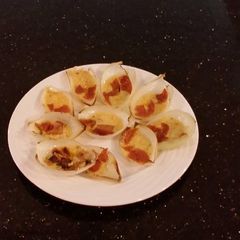 A picture of Pan Roasted Cheese Filled Onion Petals with Bacon a6nd Pepperoni.