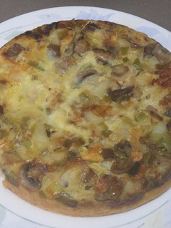 Una foto de Tortilla de patatas con ajos tiernos y setas