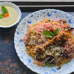 Smokey tandoori chicken drumsticks biryani with mint mango raita A picture of Smokey tandoori chicken drumsticks biryani with mint mango raita.