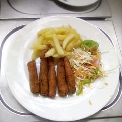 A picture of Fish fingers with French fries and coleslaw salad.