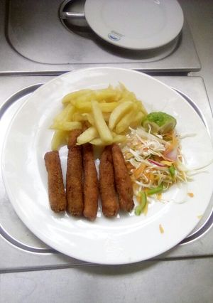A picture of Fish fingers with French fries and coleslaw salad.
