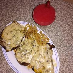 A picture of Grilled steak with homemade mushroom sauce and Spur style onion.