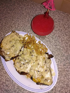 A picture of Grilled steak with homemade mushroom sauce and Spur style onion.