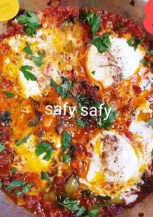 A picture of Shakshuka with Eggs and Pastrami.