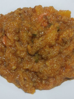 Una foto de Guiso naranja de polenta y calabacin