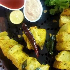 A picture of Fried Stick green gram idli with peanut chutney.