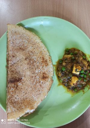 A picture of Brown rice mix lentils dosa with aalu matar korma.
