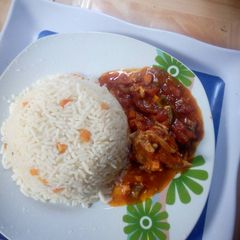 A picture of White rice and chicken stew.