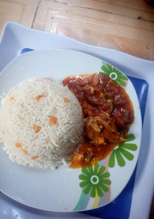 A picture of White rice and chicken stew.