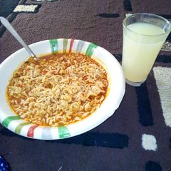 A picture of Noodles with ginger drink.