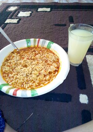 A picture of Noodles with ginger drink.