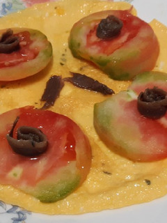 Una foto de Tortilla abierta con tomate y anchoas