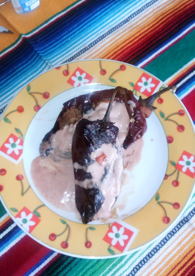 Una foto de Chiles rellenos bañados en crema de nuez moscada