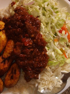 A picture of Rice and stew with plaintain.