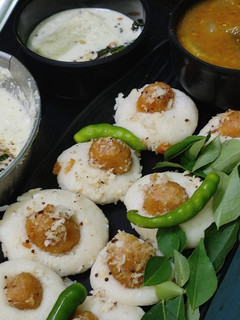 A picture of Mini Ammini kozhukattai stuffed idli with chutney&Sambar.
