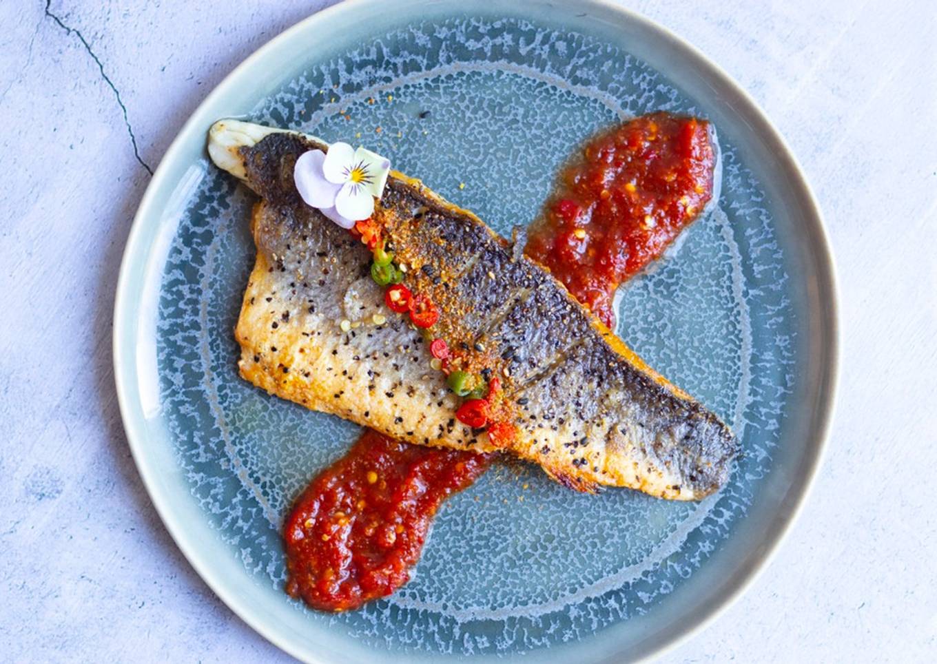 Pan fried sea-bass with spicy nam pla prik dipping sauce