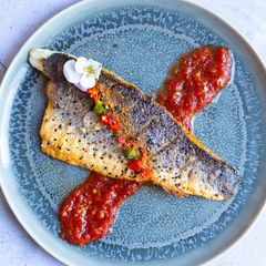 A picture of Pan fried sea-bass with spicy nam pla prik dipping sauce.