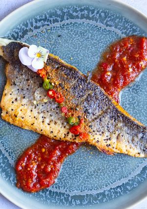 A picture of Pan fried sea-bass with spicy nam pla prik dipping sauce.
