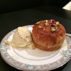 A picture of Warm honey cup pudding with pistachio frozen yoghurt.
