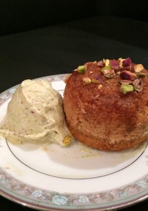 A picture of Warm honey cup pudding with pistachio frozen yoghurt.