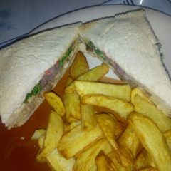 A picture of Chicken sandwich with chips.