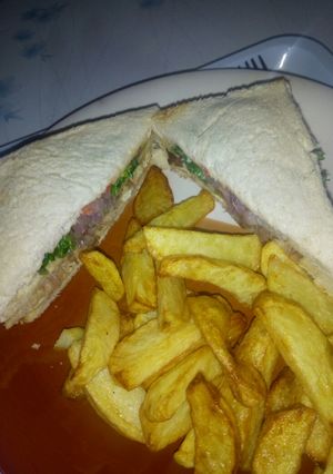 A picture of Chicken sandwich with chips.
