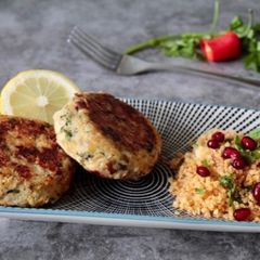 A picture of Smoked haddock Fish cake with pomegranate couscous.