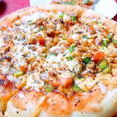 A picture of Chicken Tikka pizza.