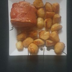 A picture of Pork joint and Roast Potatoes.