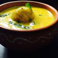 A picture of Paneer koftas in curd gravy.