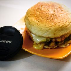 A picture of Cheezy grill burgers with homemade orange sauce (tikka sauce).