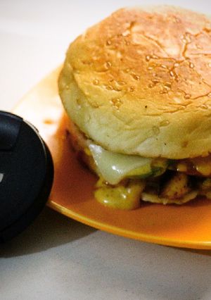 A picture of Cheezy grill burgers with homemade orange sauce (tikka sauce).