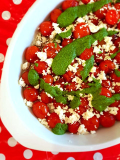 A picture of Blistered tomato, feta and basil & morogo pesto salad.